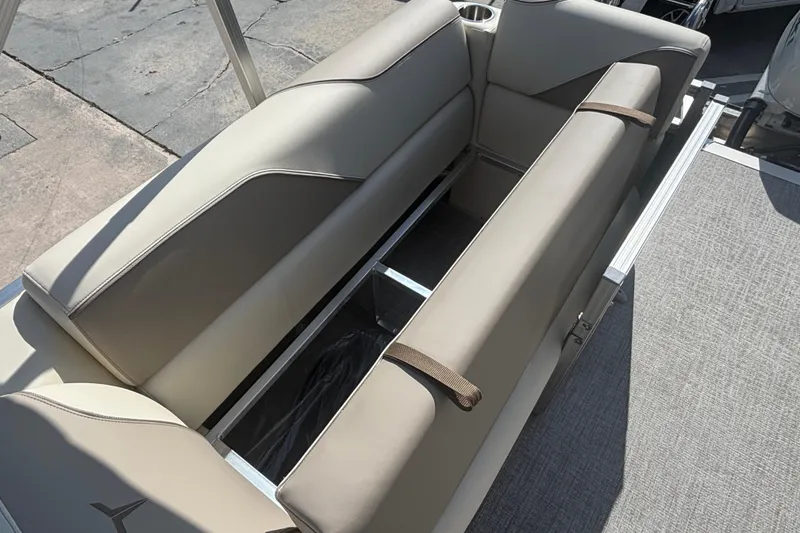 Slide: The Image of 2026 Tahoe Pontoon 21 boat interior with beige seating and storage compartment. - 6