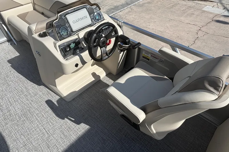 Slide: The Image of 2026 Tahoe Pontoon 21 boat interior with steering console and Garmin display. - 9