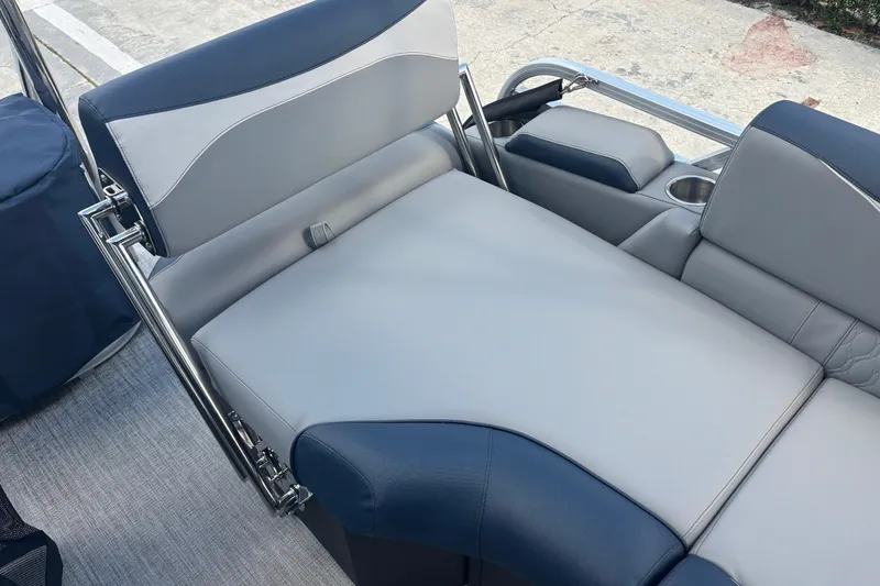 Slide: The Image of 2026 Tahoe Pontoons 23 LTZ Quad Lounge switch, featuring luxurious seating and cup holders. - 12