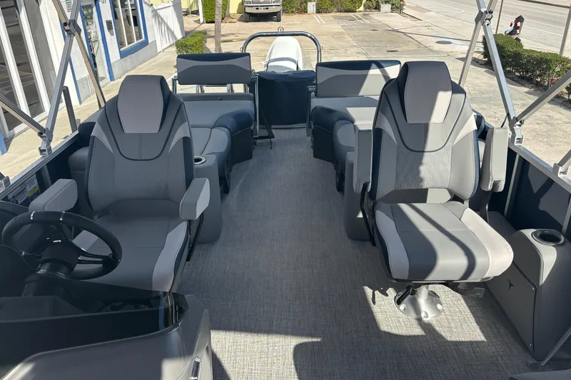 Slide: The Image of 2026 Tahoe Pontoons 23 LTZ Quad Lounge switch interior with modern seating and steering wheel. - 8