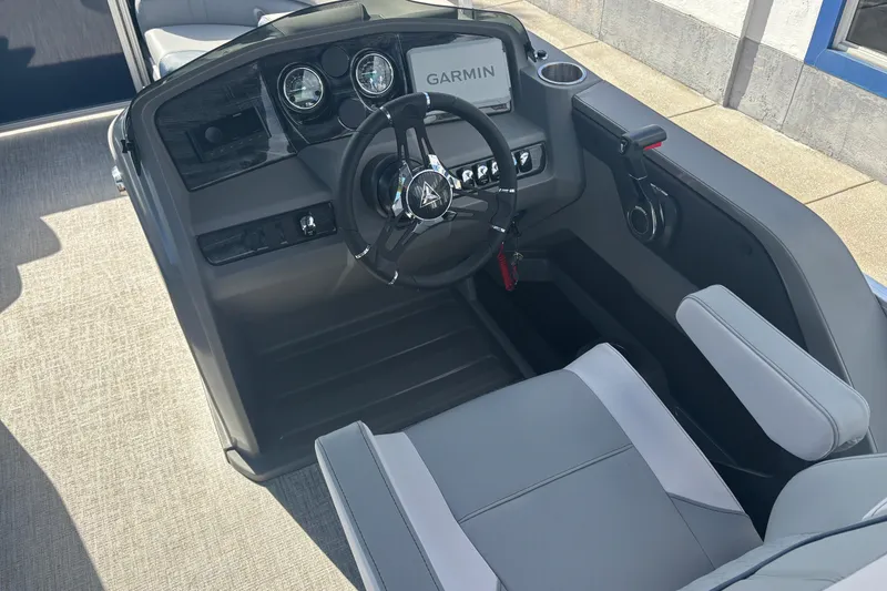 Slide: The Image of 2026 Tahoe Pontoons 23 LTZ Quad Lounge switch dashboard with Garmin display and modern controls. - 9
