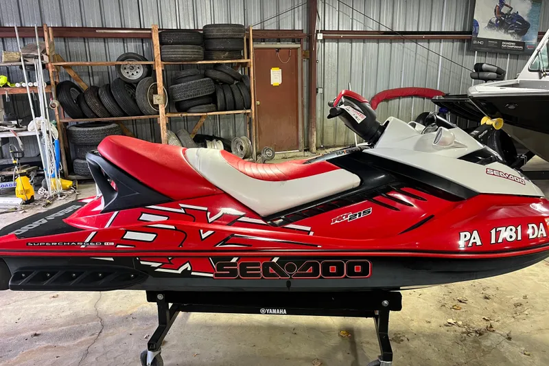 Slide: The Image of 2007 Sea-Doo RXT 215 jet ski in a garage, red and white design. - 2