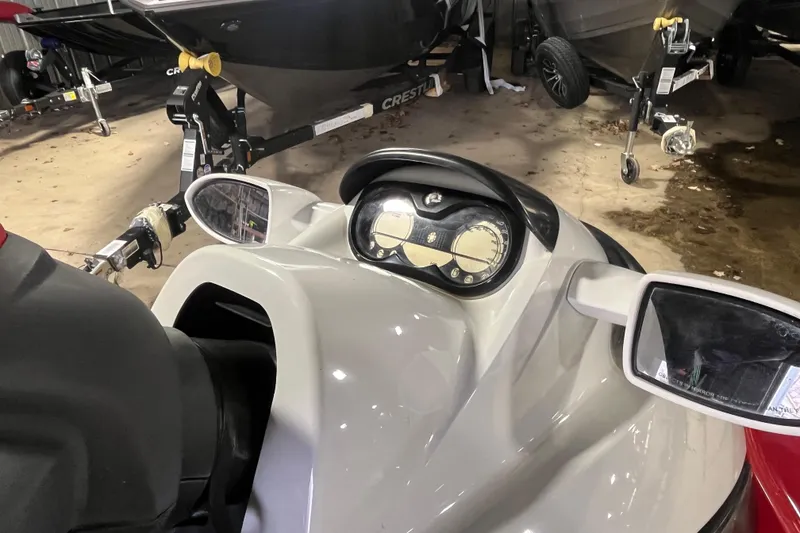 Slide: The Image of 2007 Sea-Doo RXT 215 jet ski dashboard and mirrors in a garage setting. - 5