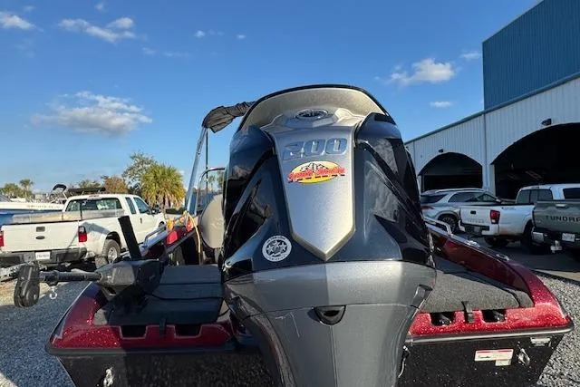Slide: The Image of 2023 Skeeter Solera 189 boat with powerful engine, parked outdoors under blue sky. - 11