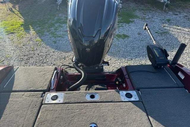 Slide: The Image of 2023 Skeeter Solera 189 boat with motor, rear deck view, parked on gravel. - 12