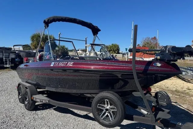 Slide: The Image of 2023 Skeeter Solera 189 boat on trailer, parked outdoors under clear blue sky. - 2