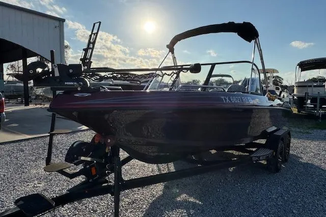 Slide: The Image of 2023 Skeeter Solera 189 boat on trailer, parked outdoors under sunny sky. - 4