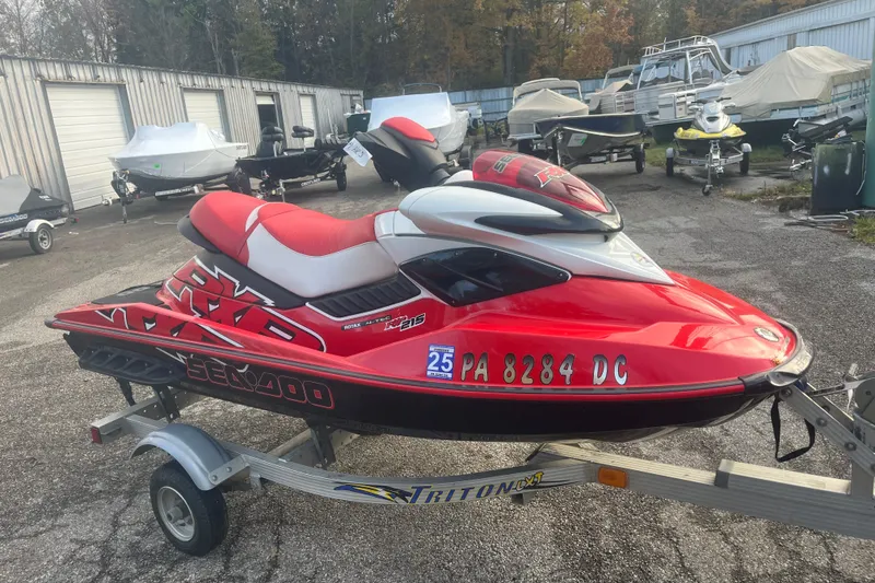 The Image of 2008 Sea-Doo RXP 215 jet ski on trailer, vibrant red and black design. - 1