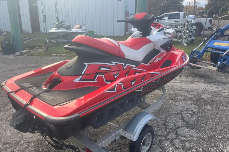 Slide: The Image of 2008 Sea-Doo RXP 215 jet ski in red and white on a trailer. - 2