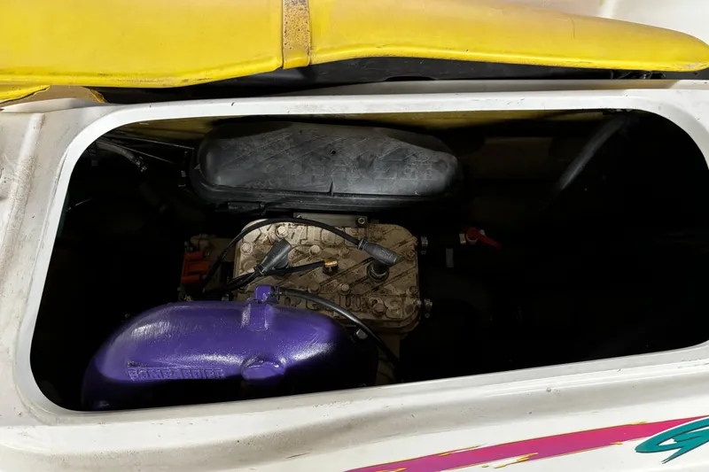 Slide: The Image of 1996 Sea-Doo GTI engine compartment with visible components and yellow seat. - 3