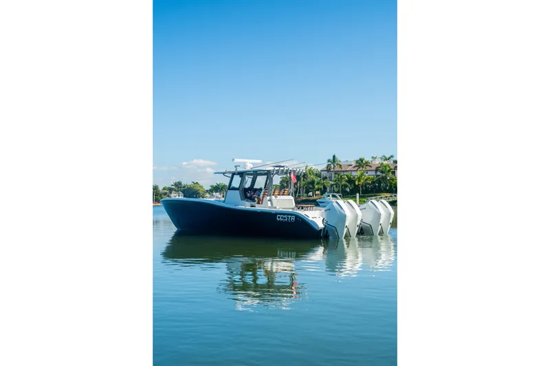 Slide: The Image of 2025 Costa Custom Boats 34 on calm water, featuring multiple outboard engines. - 11