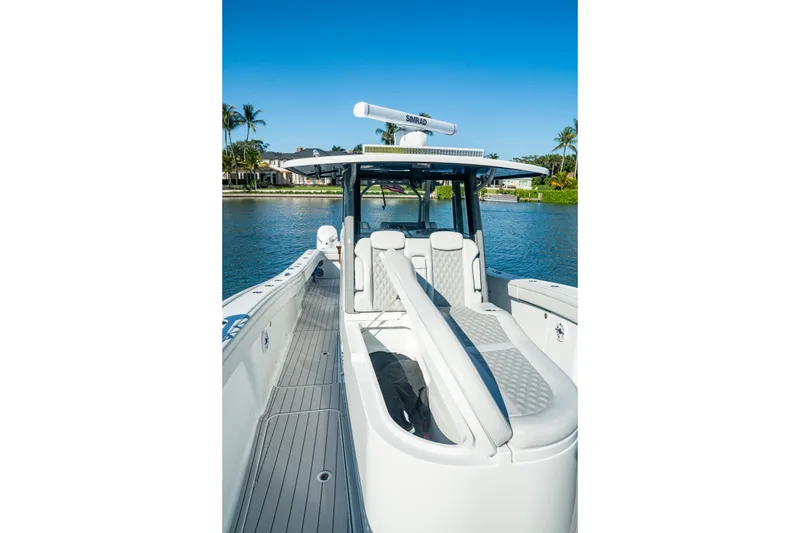 Slide: The Image of 2025 Costa Custom Boats 34 model on serene water, showcasing sleek design and luxury features. - 15