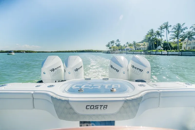 Slide: The Image of 2025 Costa Custom Boats 34 with triple engines cruising on a sunny day. - 18
