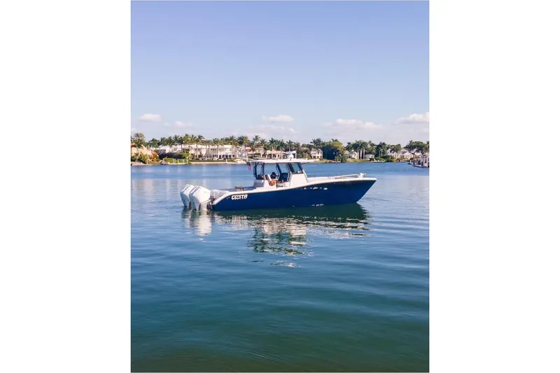 Slide: The Image of 2025 Costa Custom Boats 34 on calm water, showcasing sleek design and powerful engines. - 20