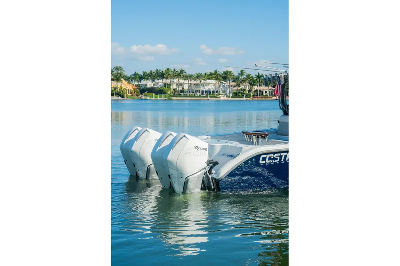 Slide: The Image of 2025 Costa Custom Boats 34 with twin engines on a serene waterway. - 4