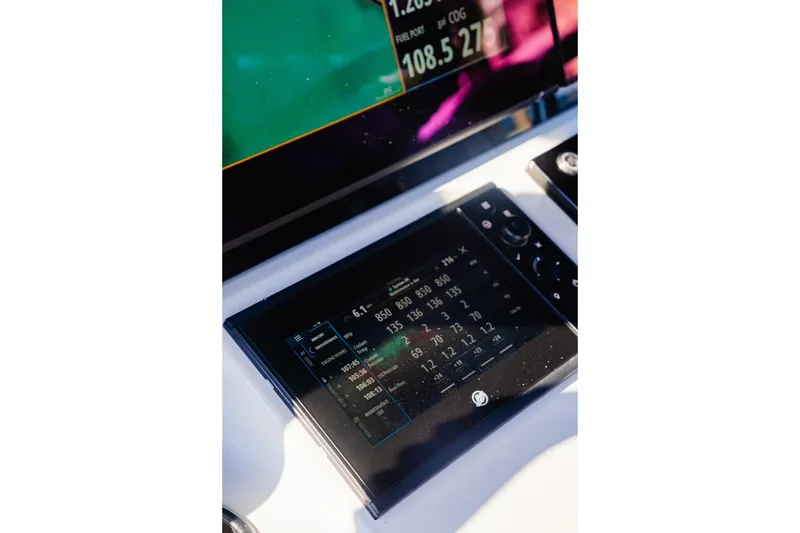Slide: The Image of Dashboard of 2025 Costa Custom Boats 34 with digital display and controls. - 5