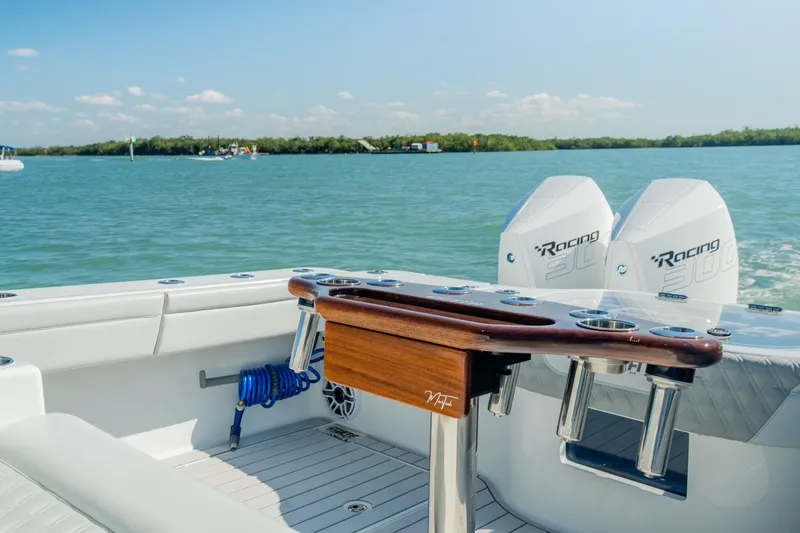Slide: The Image of 2025 Costa Custom Boats 34 with dual Racing 300 engines on calm water. - 8