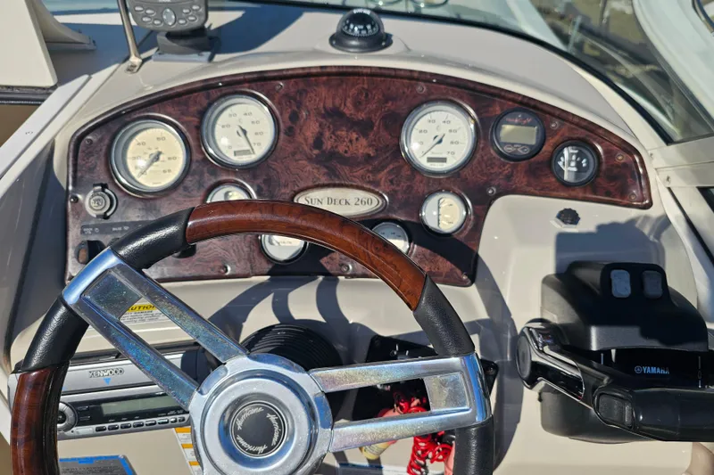Slide: The Image of Dashboard of a 2006 Hurricane SunDeck 260 OB boat with gauges and steering wheel. - 15