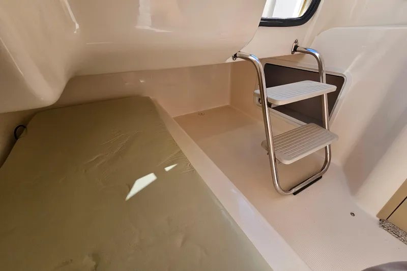 Slide: The Image of Interior of 2006 Hurricane SunDeck 260 OB boat with ladder and seating area. - 19