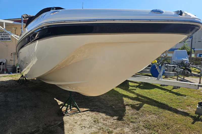 Slide: The Image of 2006 Hurricane SunDeck 260 OB boat on stands, side view. - 2