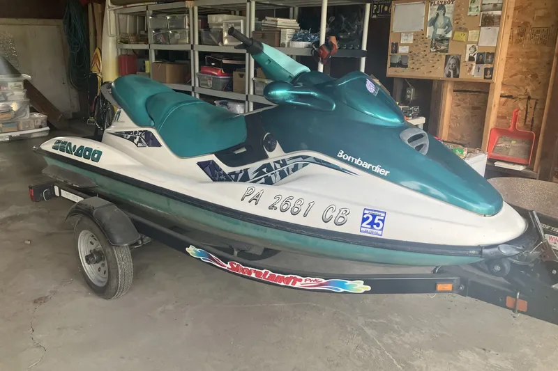 The Image of 1998 Sea-Doo GTI jet ski on trailer in garage setting. - 1
