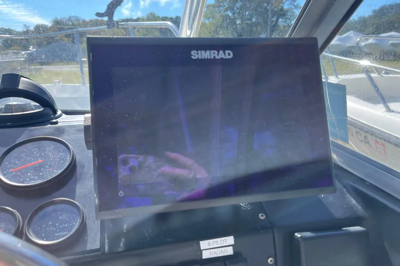 Slide: The Image of Simrad display on 1992 Bayliner Trophy 2000 boat dashboard with gauges and controls. - 11