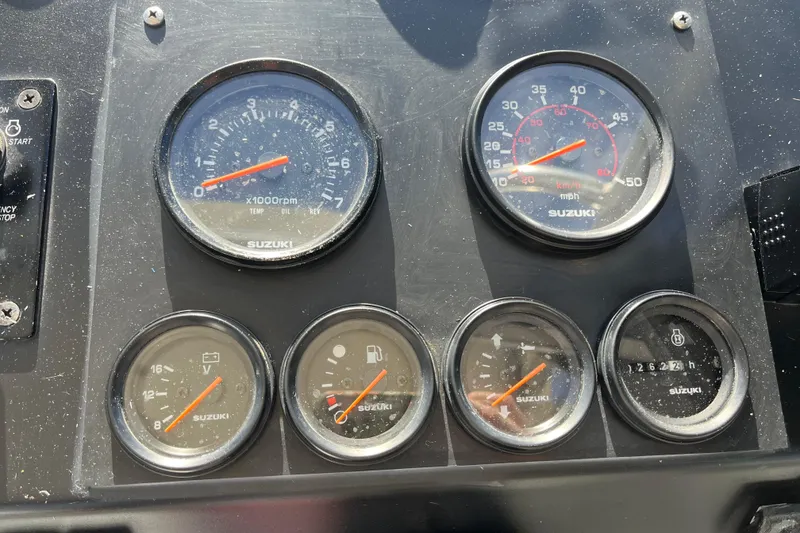 Slide: The Image of Dashboard of a 1992 Bayliner Trophy boat with Suzuki gauges and controls. - 13
