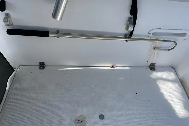 Slide: The Image of Interior of 1992 Bayliner Trophy 2000 boat showing storage area and mounted rod holder. - 14