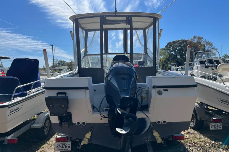Slide: The Image of 1992 Bayliner Trophy 2000 boat with outboard motor, parked on a sunny day. - 20