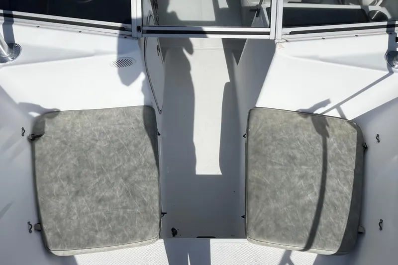 Slide: The Image of 1992 Bayliner Trophy 2000 boat interior with gray cushioned seats and white deck. - 7