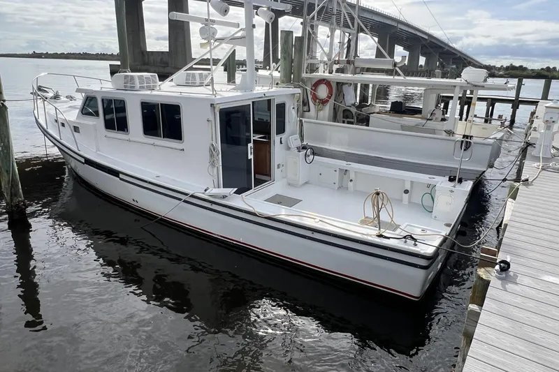 The Image of 2006 Provincial 42 Lobster Boat docked near a bridge on a calm day. - 0