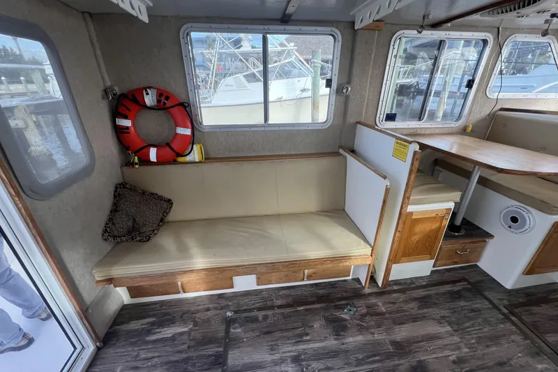 Slide: The Image of Interior of 2006 Provincial 42 Lobster Boat with seating, table, and life preserver. - 18
