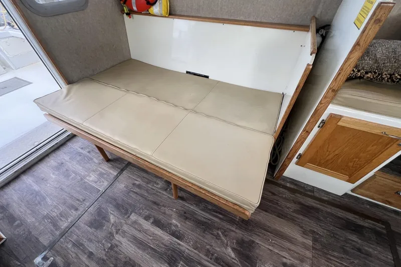 Slide: The Image of Interior of 2006 Provincial 42 Lobster Boat with beige cushioned seating and wooden flooring. - 19