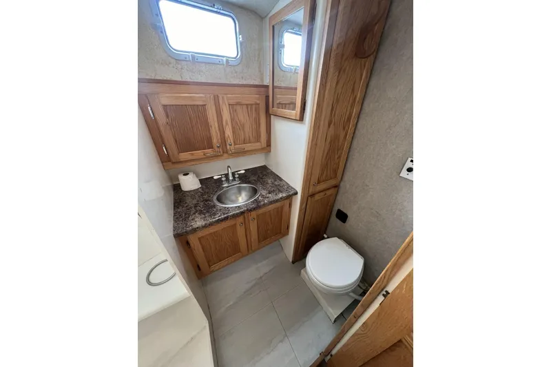 Slide: The Image of Bathroom interior of 2006 Provincial 42 Lobster Boat with wooden cabinets and compact design. - 21