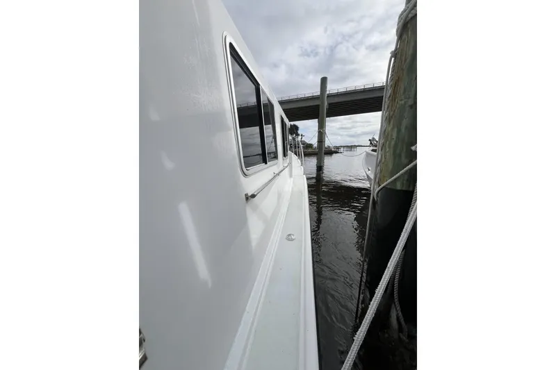 Slide: The Image of 2006 Provincial 42 Lobster Boat docked beside a pier under cloudy skies. - 3