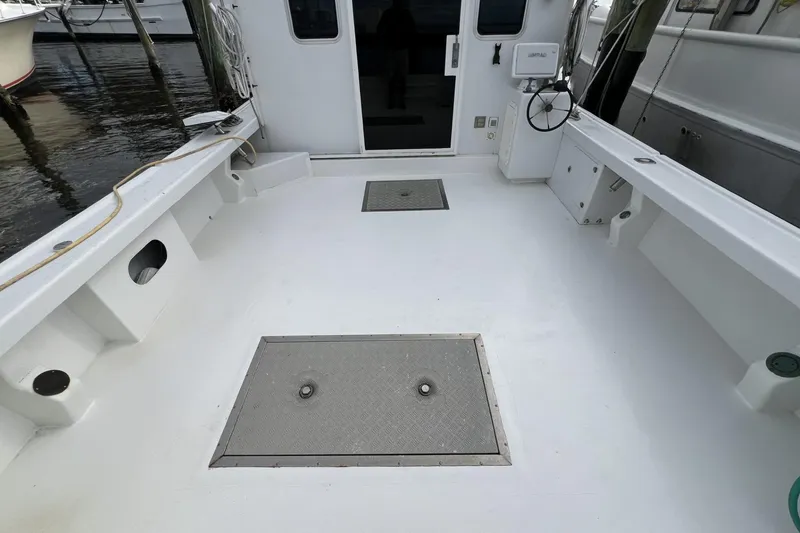 Slide: The Image of 2006 Provincial 42 Lobster Boat deck with storage hatches and clean white surface. - 8