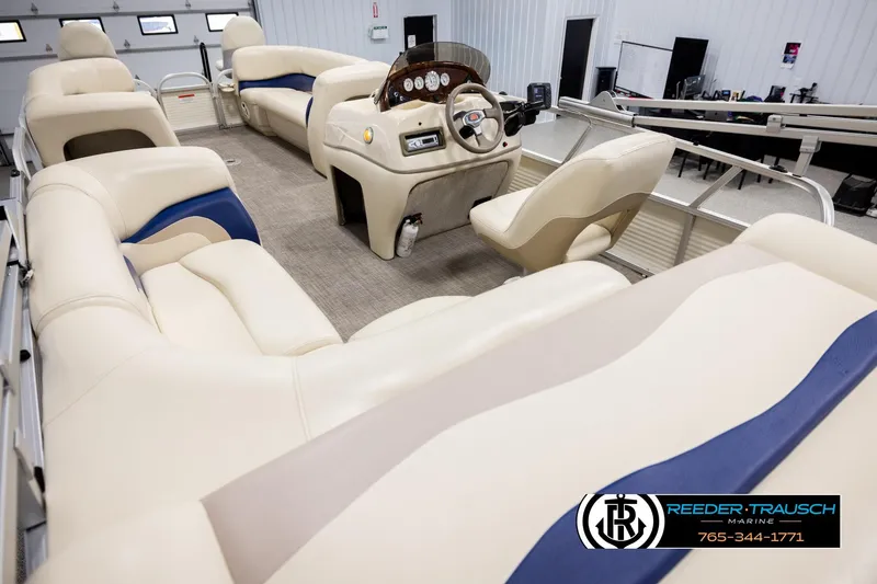 Slide: The Image of 2008 Sun Tracker Party Barge 24 interior with plush seating and modern dashboard. - 10