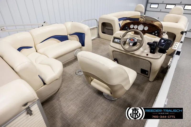 Slide: The Image of 2008 Sun Tracker Party Barge 24 interior with beige seating and control panel. - 11