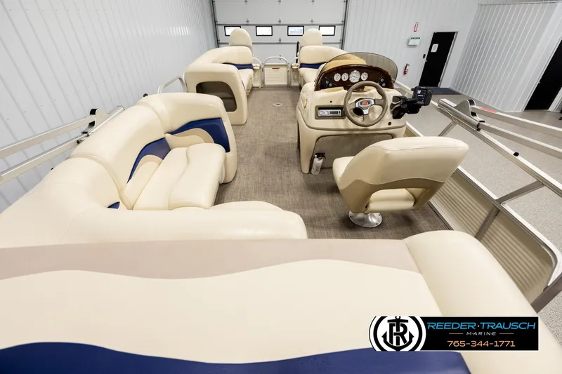 Slide: The Image of 2008 Sun Tracker Party Barge 24 interior with beige and blue seating, steering console. - 15