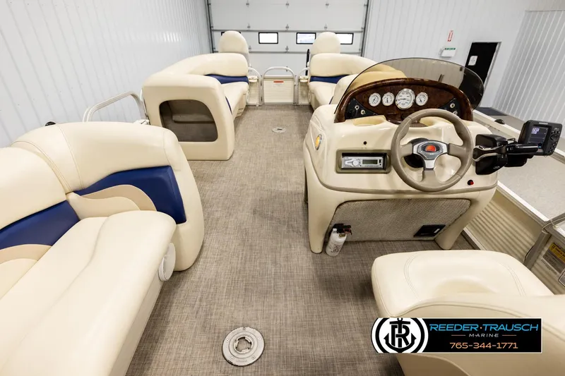 Slide: The Image of 2008 Sun Tracker Party Barge 24 interior with beige seating and control panel. - 16