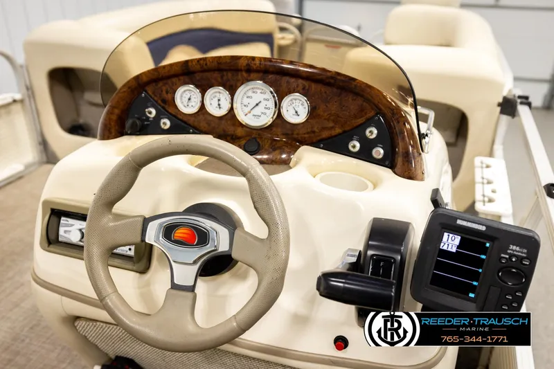 Slide: The Image of 2008 Sun Tracker Party Barge 24 dashboard with steering wheel and control panel. - 19