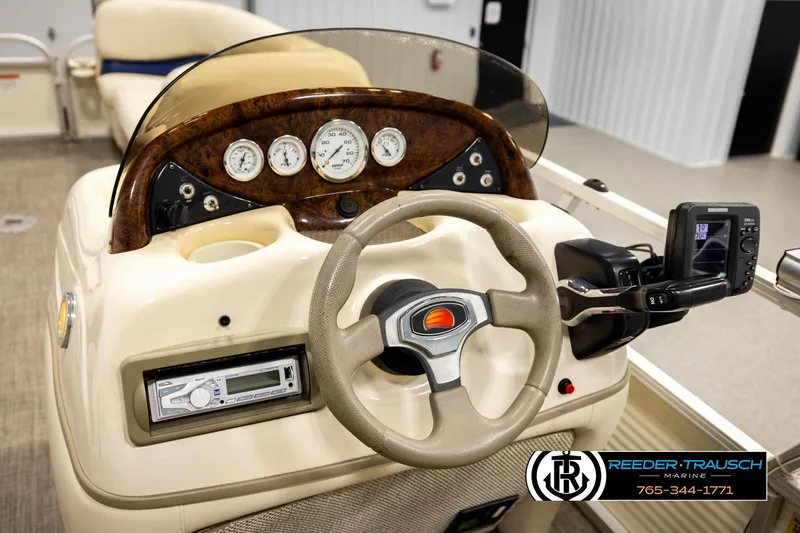 Slide: The Image of 2008 Sun Tracker Party Barge 24 dashboard with steering wheel and gauges. - 20
