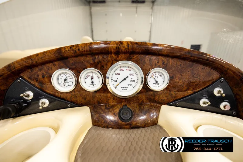 Slide: The Image of 2008 Sun Tracker Party Barge 24 dashboard with gauges and controls in a wood finish. - 23