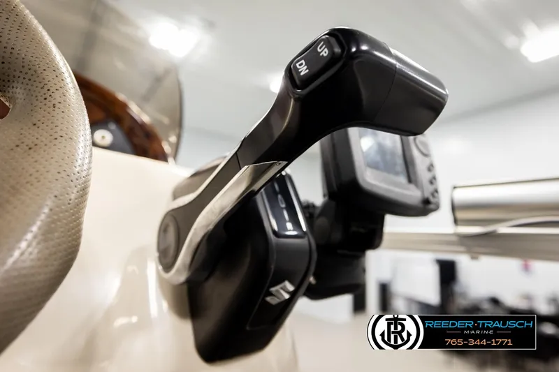 Slide: The Image of Close-up of 2008 Sun Tracker Party Barge 24 throttle control and steering wheel. - 25