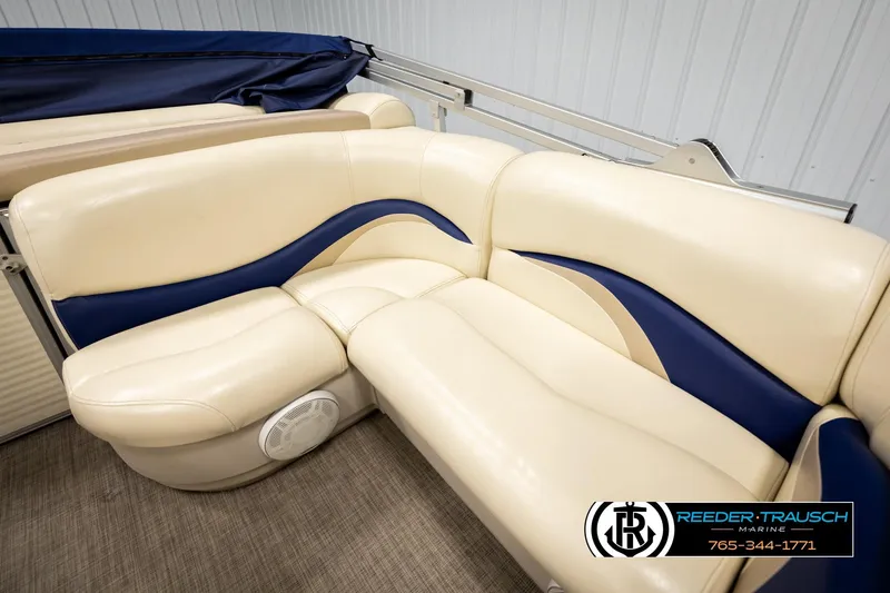Slide: The Image of 2008 Sun Tracker Party Barge 24 interior seating with beige and blue upholstery. - 28