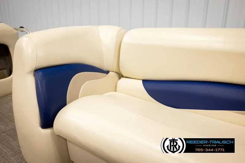 Slide: The Image of 2008 Sun Tracker Party Barge 24 interior seating with beige and blue upholstery. - 29