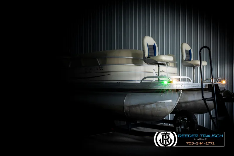 Slide: The Image of 2008 Sun Tracker Party Barge 24 pontoon boat in dimly lit storage. - 3