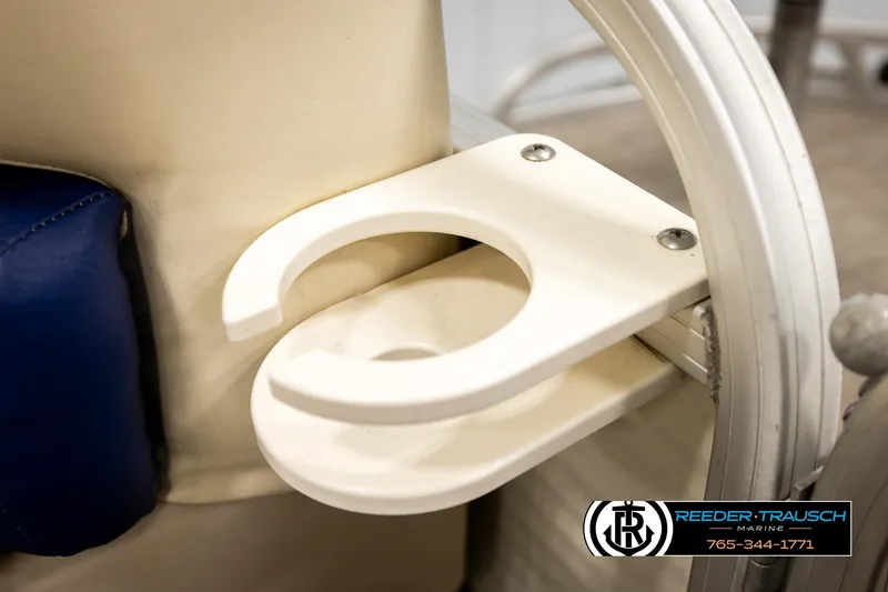 Slide: The Image of Cup holder on 2008 Sun Tracker Party Barge 24 boat, featuring beige and blue seating. - 34