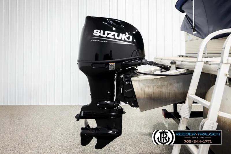 Slide: The Image of 2008 Sun Tracker Party Barge 24 with Suzuki outboard motor, displayed indoors. - 35