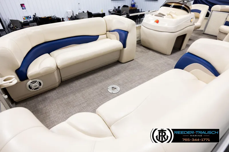 Slide: The Image of 2008 Sun Tracker Party Barge 24 interior with beige and blue seating, spacious layout. - 9